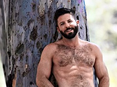 Hairy gay enjoys stroking hard cock while masturbating