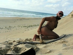Tattooed guy drills his ass and jerks his cock on the beach