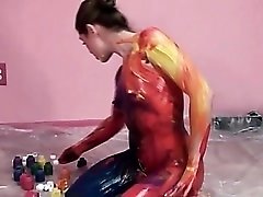 She slowly coats her entire body in paint