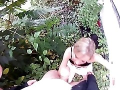 They get into the bushes so she can suck his dick